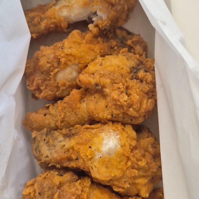 A takeaway box packed with golden fried chicken