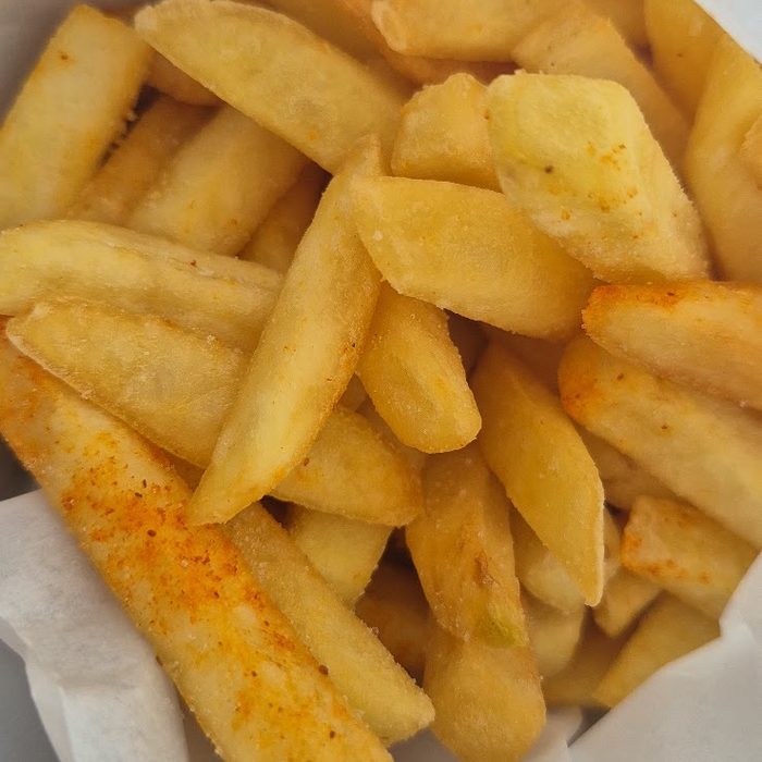 A close-up of seasoned thick-cut chips